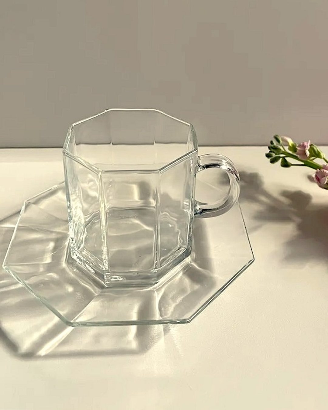 Arcoroc Octime clear cup and saucer on a sunlit bench
